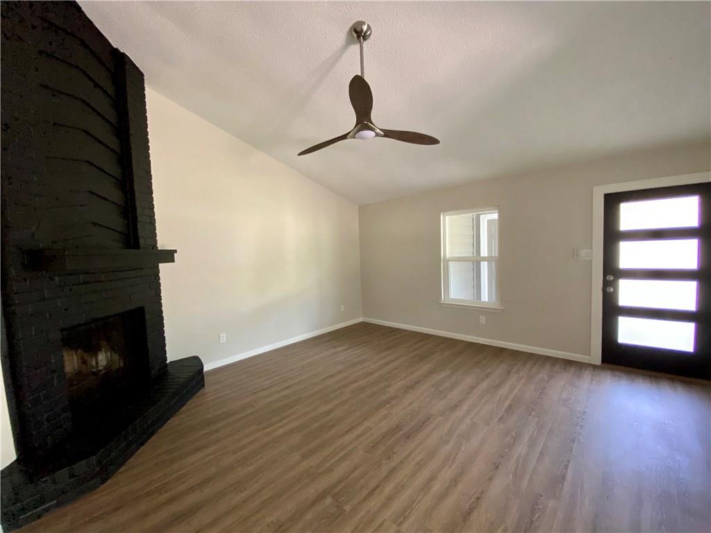 1715 Shadowview Drive, Unit B Austin, TX 78758 - Photo 12 of 28 A striking fireplace and vaulted ceilings define this inviting living space.