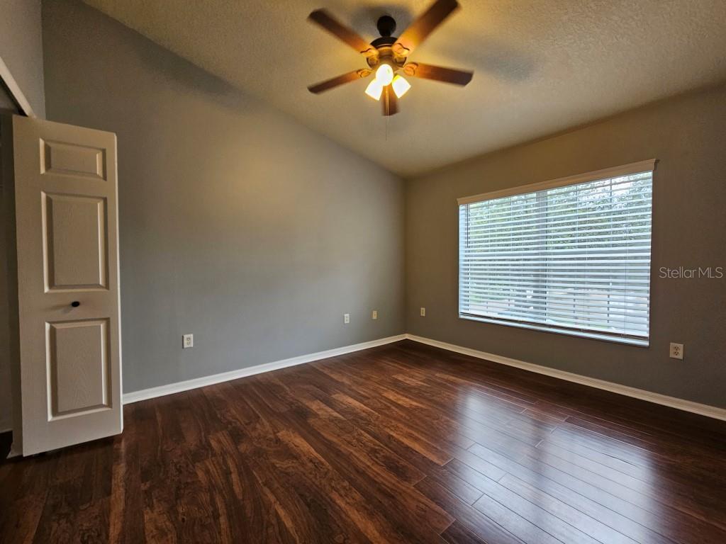 1404 Blue Magnolia Road Brandon, FL 33510 - Photo 14 of 21 a view of empty room with wooden floor and fan