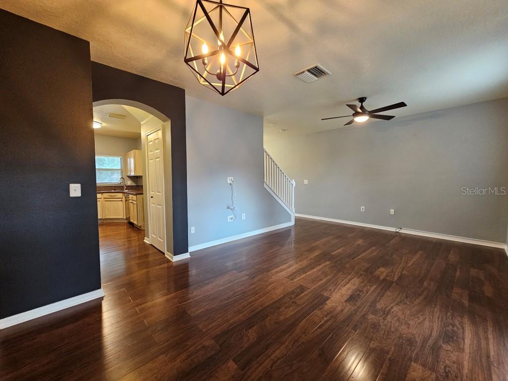 1404 Blue Magnolia Road Brandon, FL 33510 - Photo 4 of 21 wooden floor in an empty room with a chandelier