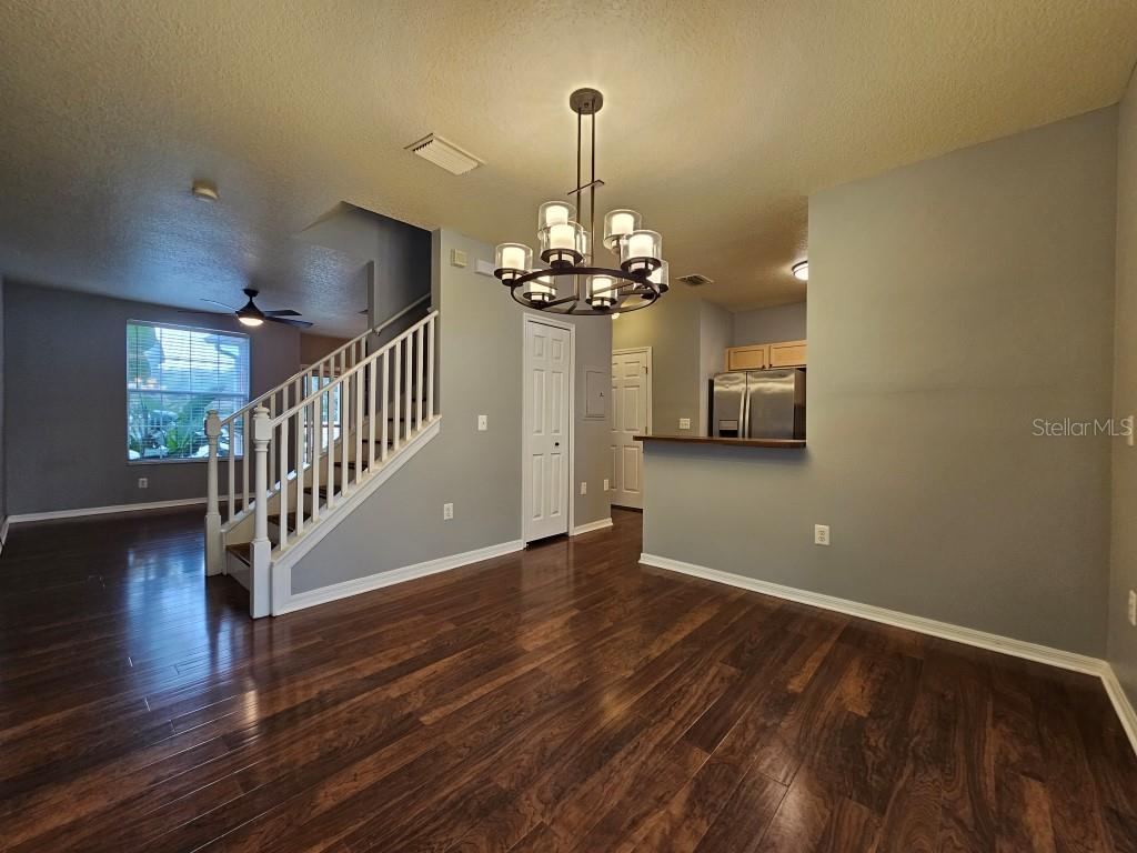 1404 Blue Magnolia Road Brandon, FL 33510 - Photo 6 of 21 a view of a livingroom with wooden floor staircase and a chandelier