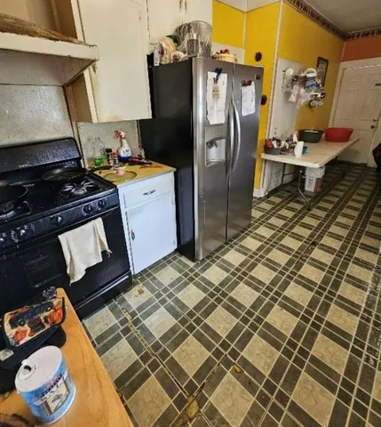 a kitchen with a refrigerator and a stove