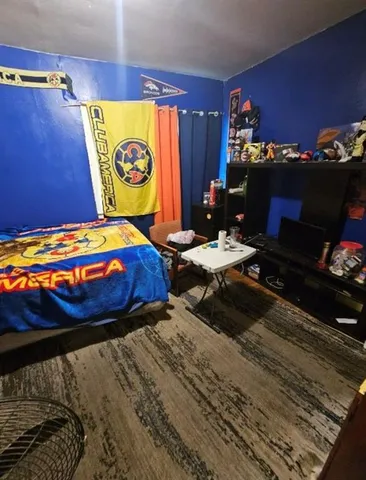 a bedroom with a bed and a table