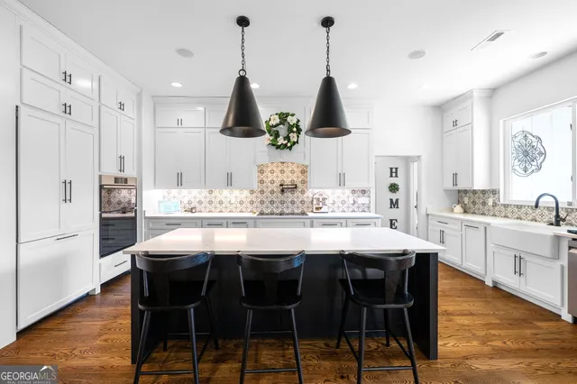 a view of a hallway with wooden floor and a living room