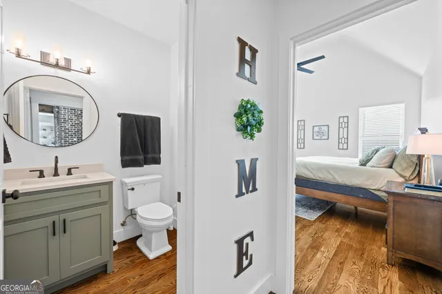 a view of a patio with table and chairs potted plants with wooden floor and fence