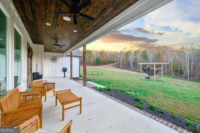 a living room with furniture pool table and a flat screen tv