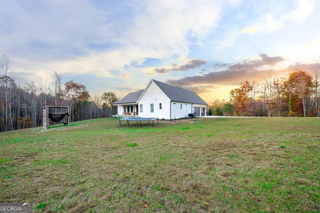 a view of a swimming pool with a table and chairs under an umbrella