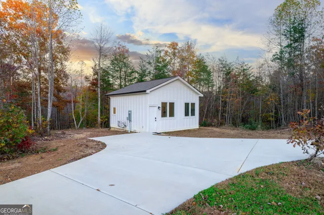 an aerial view of house with yard and mountain view in back