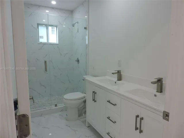 a kitchen with a refrigerator and a stove top oven