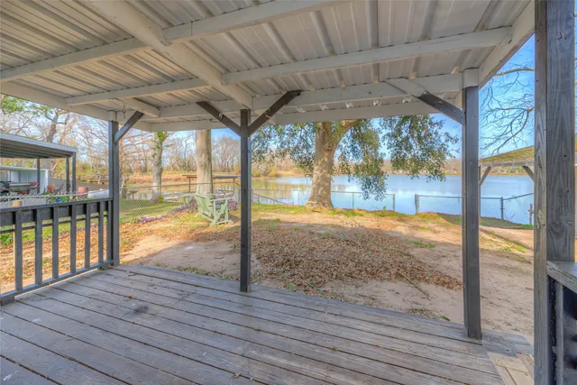 a view of an empty room with wooden floor and a floor to ceiling window