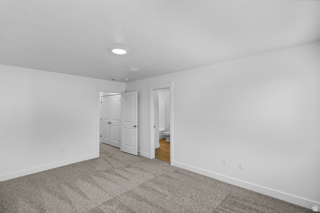 3014 South 265th Street West Logan, UT 84321 - Photo 21 of 25 Spacious room featuring neutral carpet flooring, bright white walls, a single recessed ceiling light fixture, and white baseboards