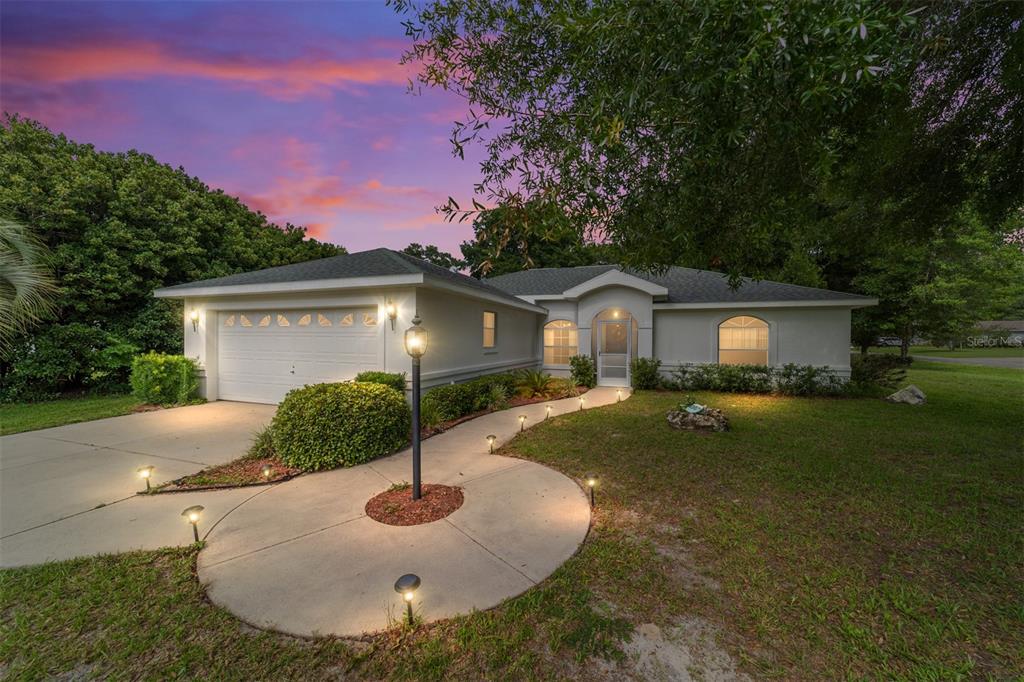 a front view of house with yard and trees