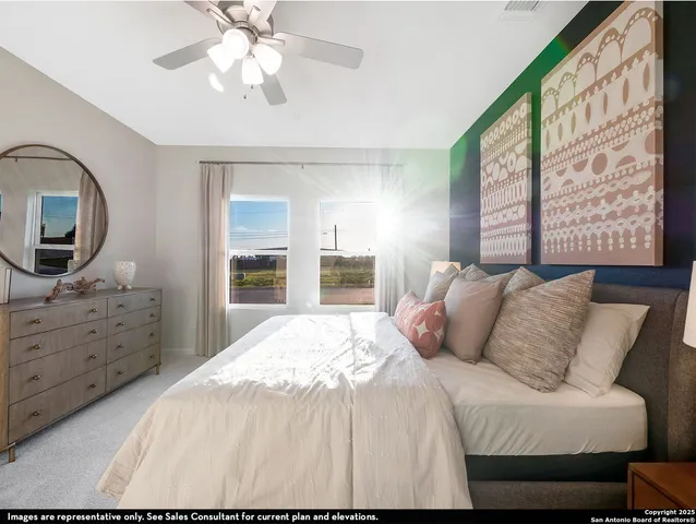 a bedroom with a large bed and a flat tv screen on dresser