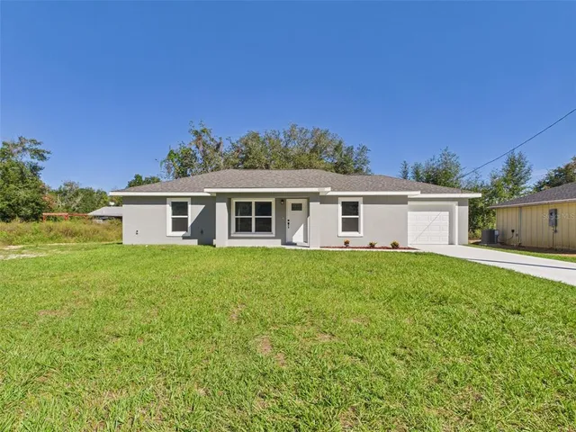 a view of a yard with a house in the background