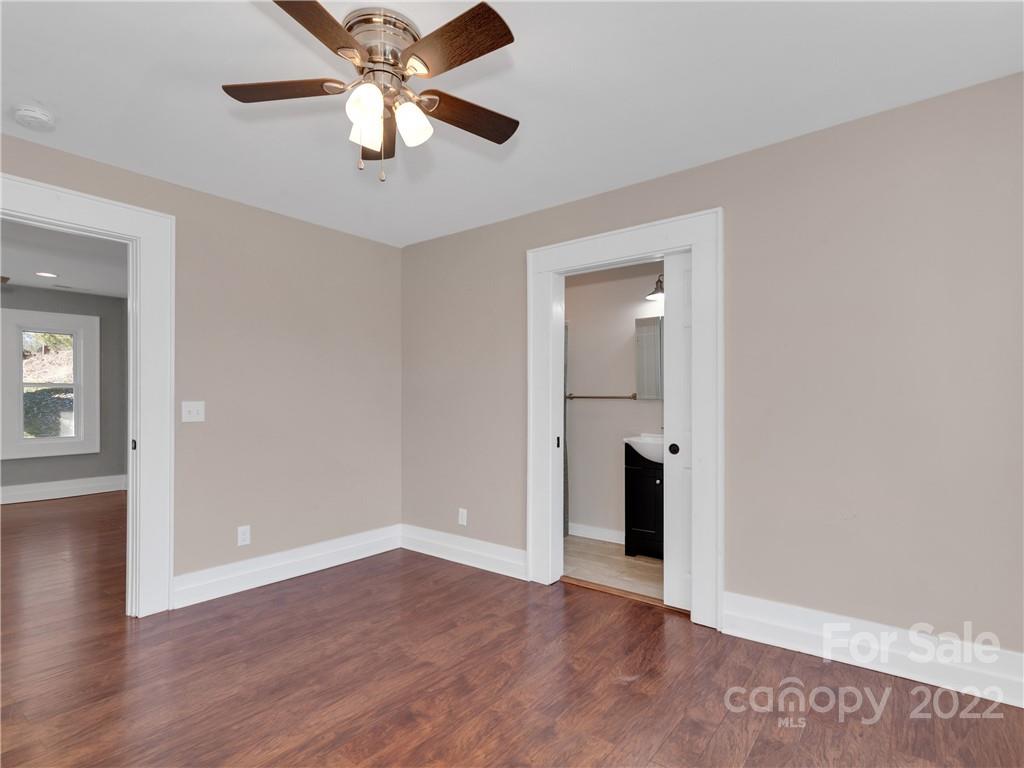 1739 Old Clyde Road Clyde, NC 28721 - Photo 16 of 24 wooden floor in an empty room with a window