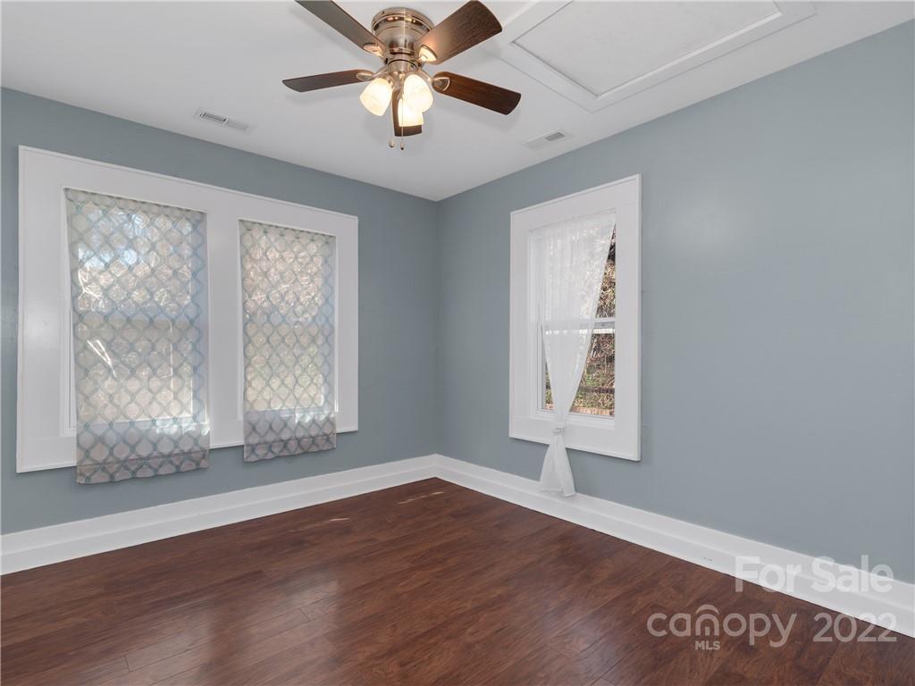 1739 Old Clyde Road Clyde, NC 28721 - Photo 20 of 24 a view of an empty room with wooden floor and a window
