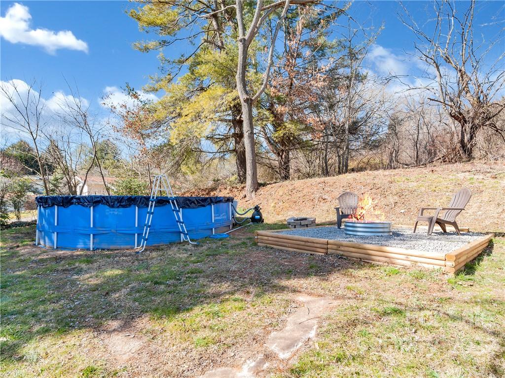 1739 Old Clyde Road Clyde, NC 28721 - Photo 23 of 24 a view of a backyard with large trees and wooden fence