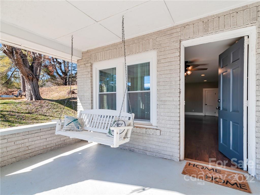 1739 Old Clyde Road Clyde, NC 28721 - Photo 5 of 24 a view of a porch with a table and chairs