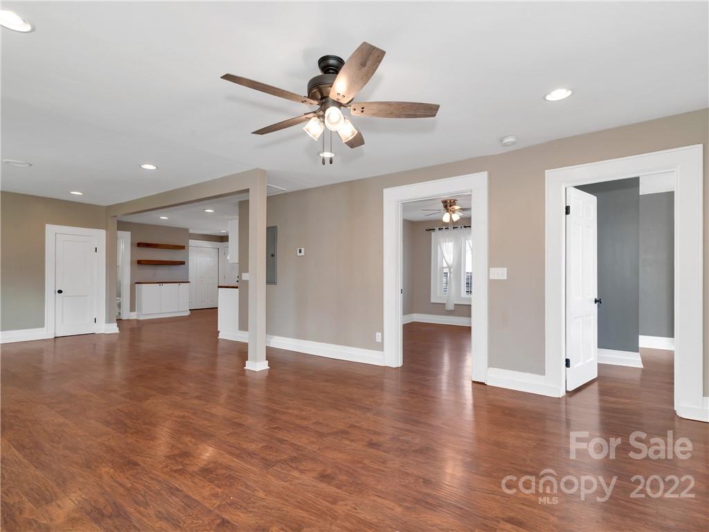 1739 Old Clyde Road Clyde, NC 28721 - Photo 10 of 24 a view of an empty room with wooden floor and a ceiling fan