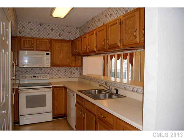 19823 Henderson Road, Unit E Cornelius, NC 28031 - Photo 5 of 14 a kitchen with stainless steel appliances granite countertop a sink stove and cabinets
