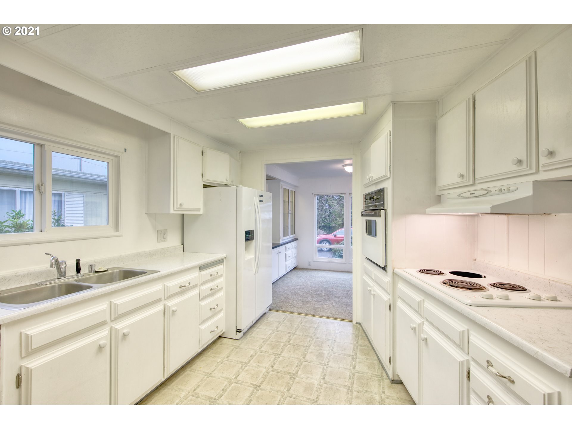 3530 Game Farm Road, Unit 46 Springfield, OR 97477 - Photo 14 of 32 a large white kitchen with cabinets