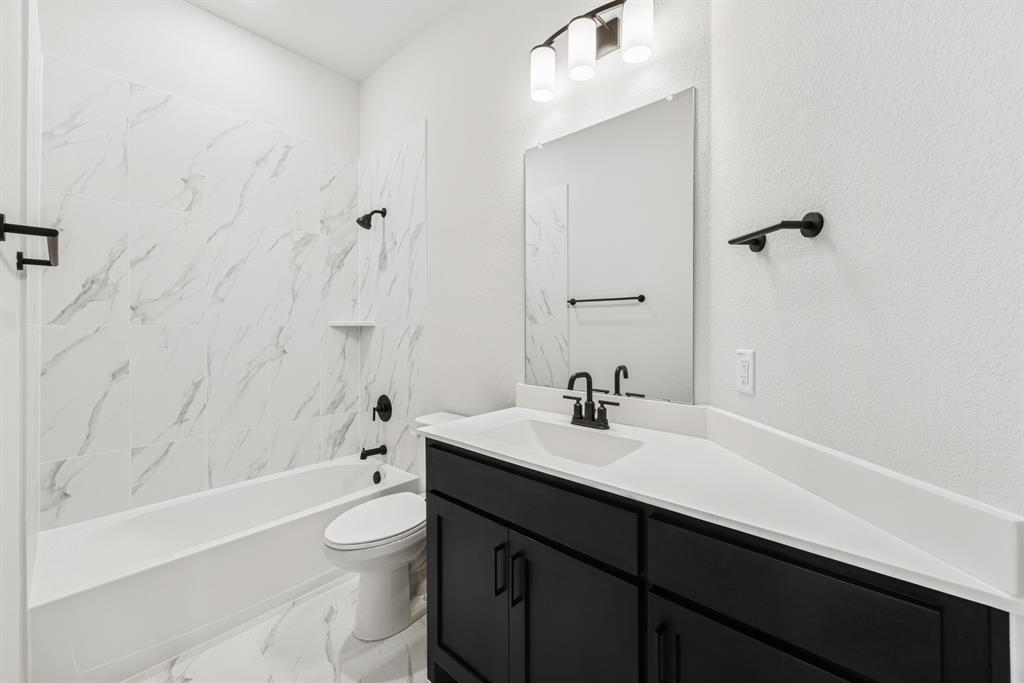 2065 Spotted Fawn Drive Arlington, TX 76005 - Photo 14 of 27 a bathroom with a sink a toilet and shower
