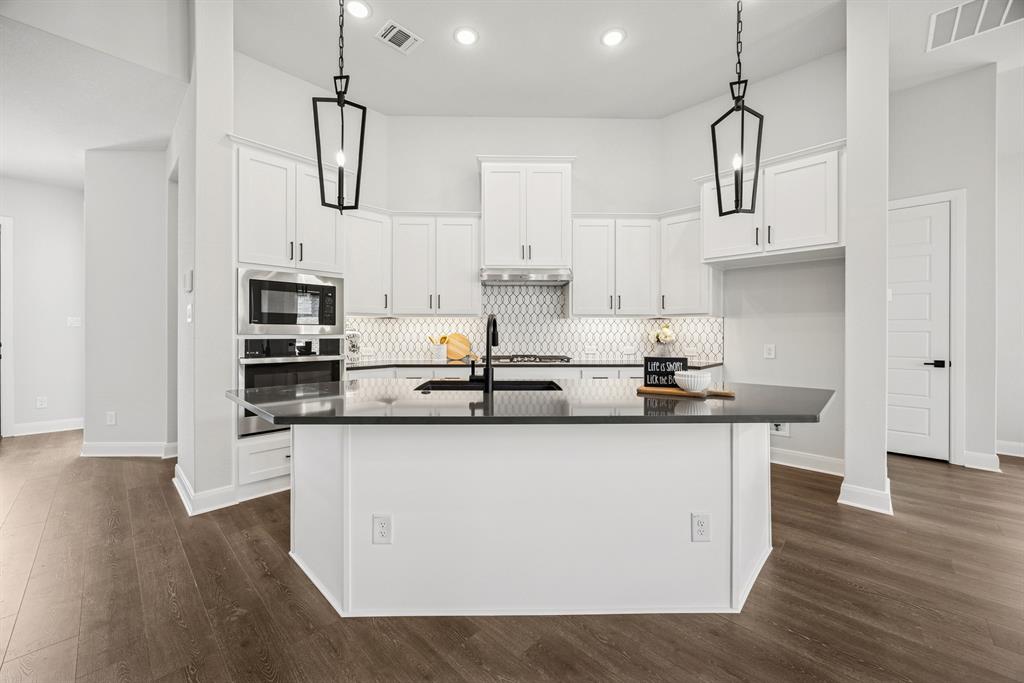2065 Spotted Fawn Drive Arlington, TX 76005 - Photo 15 of 27 a kitchen with stainless steel appliances a sink and wooden floor