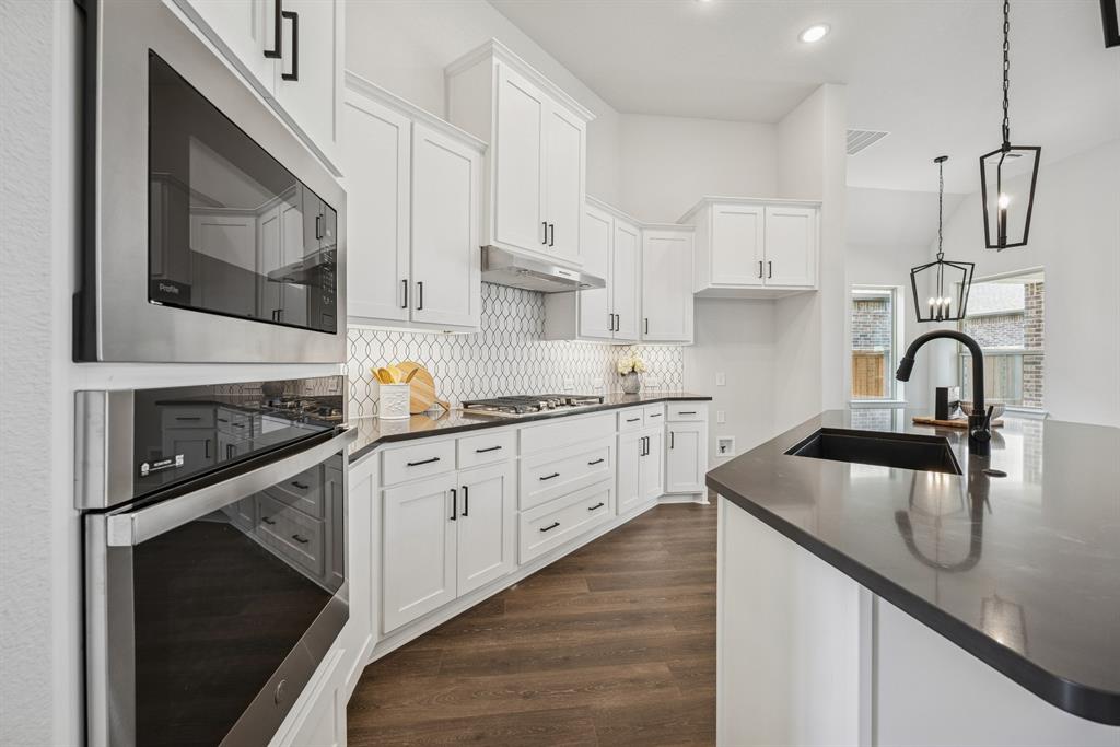 2065 Spotted Fawn Drive Arlington, TX 76005 - Photo 18 of 27 a kitchen with white cabinets stainless steel appliances and sink