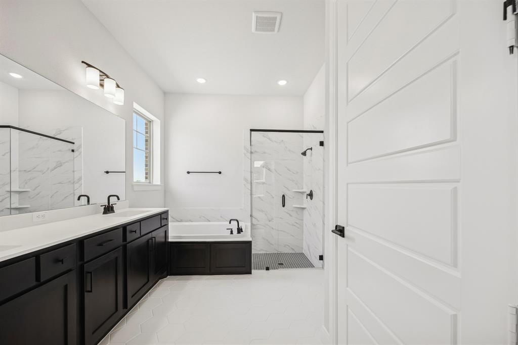 2065 Spotted Fawn Drive Arlington, TX 76005 - Photo 25 of 27 a spacious bathroom with a double vanity sink a mirror and a bathtub