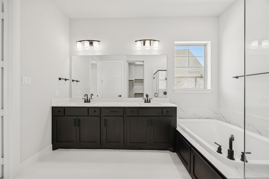 2065 Spotted Fawn Drive Arlington, TX 76005 - Photo 26 of 27 a bathroom with a tub a double vanity sink and mirror