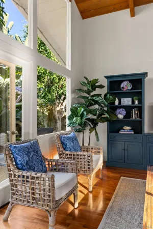 a vase of flowers sitting on a table in front of a window