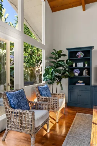 a vase of flowers sitting on a table in front of a window