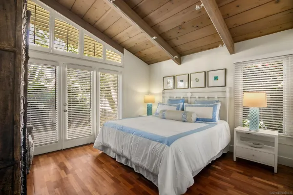 a bedroom with a large bed and a large window