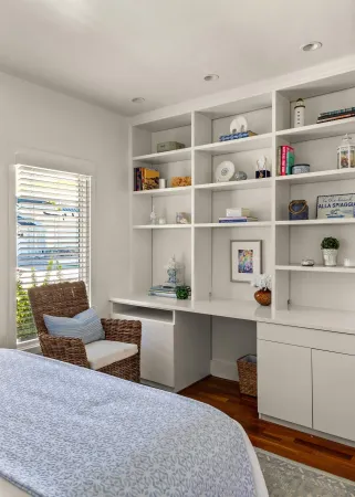 a living room with furniture cabinets and window