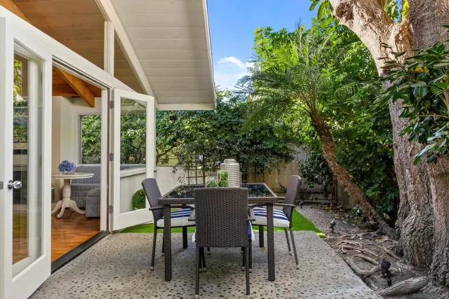 a view of a patio with table and chairs and potted plants