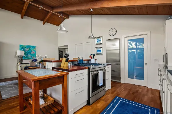a kitchen with stainless steel appliances granite countertop a stove and a refrigerator