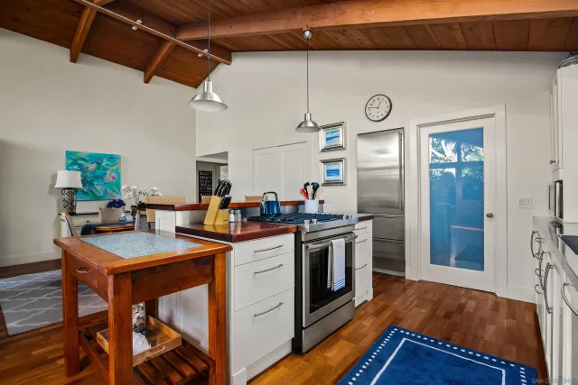 a kitchen with stainless steel appliances granite countertop a stove and a refrigerator