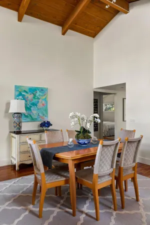 a dining room with furniture and wooden floor