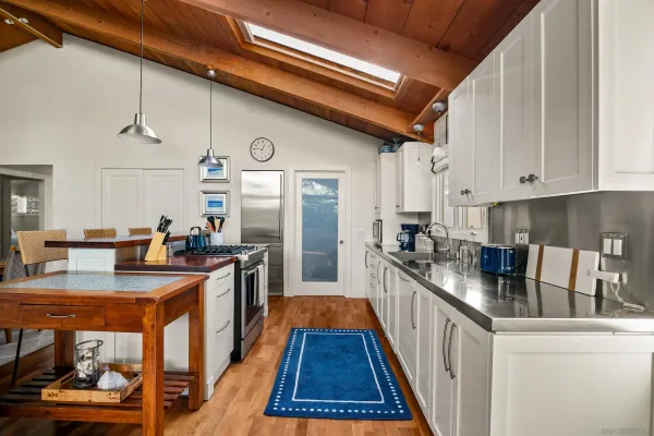 a kitchen with granite countertop lots of counter top space and stainless steel appliances