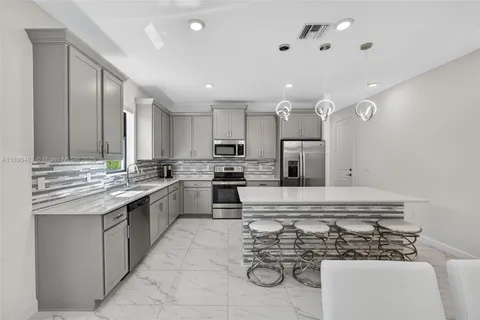 a kitchen with a sink stainless steel appliances and cabinets