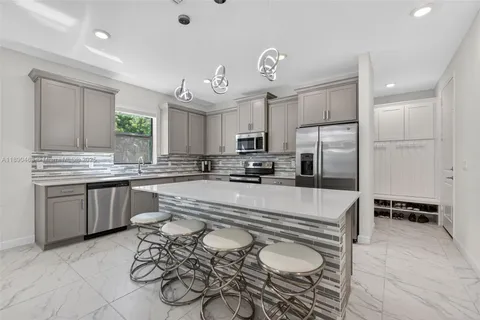 a kitchen with stainless steel appliances granite countertop a sink and stove top oven