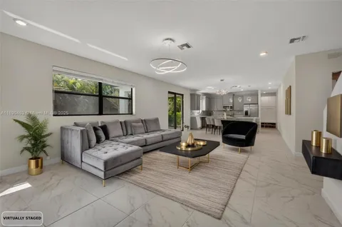 a bathroom with a granite countertop toilet sink and mirror