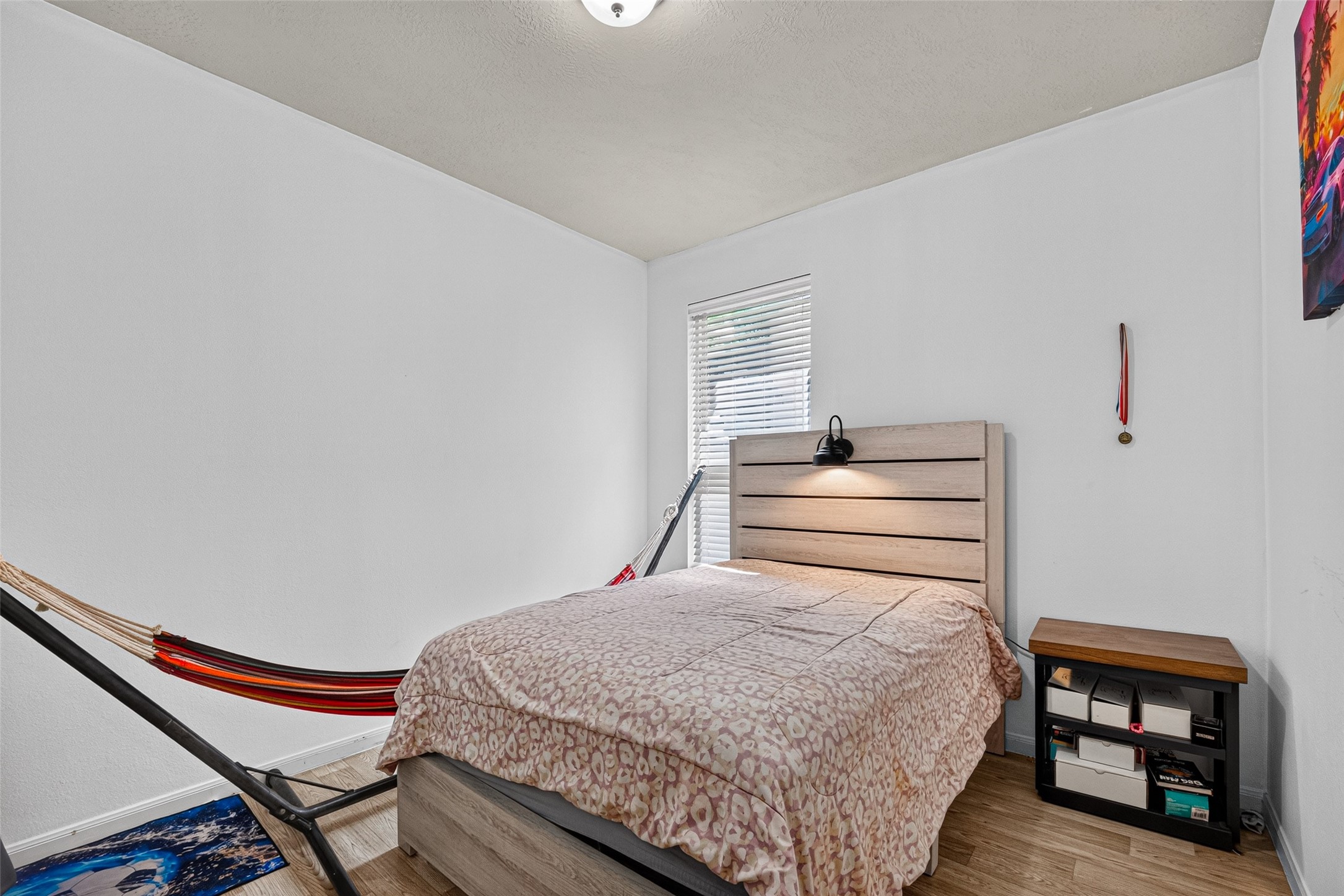 9314 Fuqua Ridge Lane Houston, TX 77075 - Photo 17 of 24 a bedroom with a bed and wooden floor