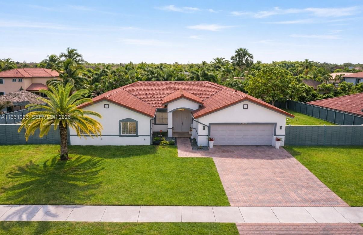 14214 Southwest 289th Terrace Homestead, FL 33033 - Photo 1 of 13 a aerial view of a house with a yard table and chairs