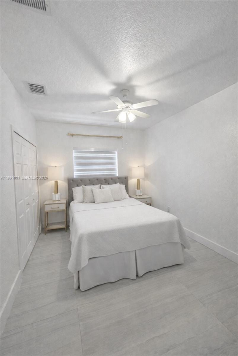 14214 Southwest 289th Terrace Homestead, FL 33033 - Photo 12 of 13 a spacious bedroom with a bed and a night stand