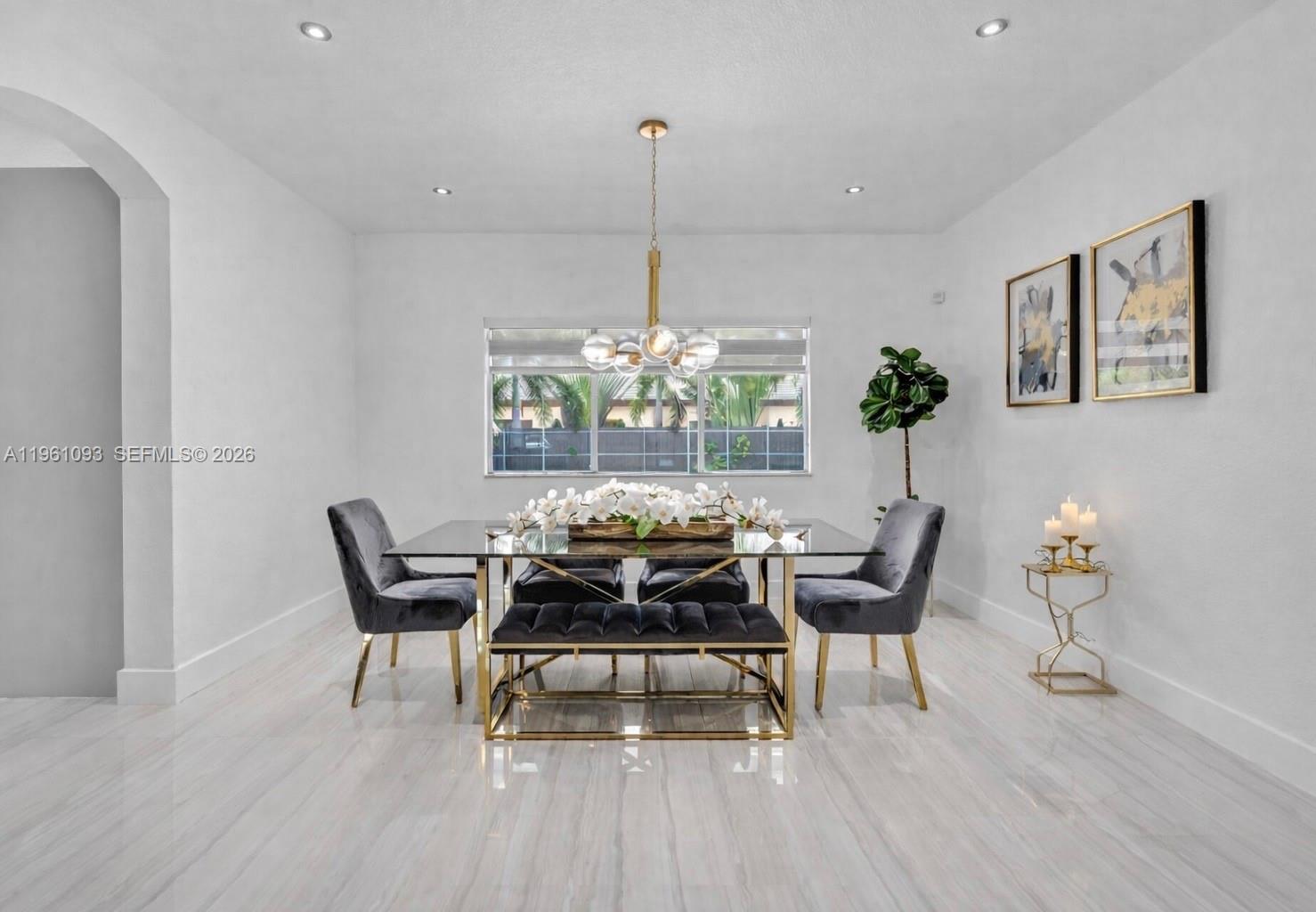 14214 Southwest 289th Terrace Homestead, FL 33033 - Photo 4 of 13 a dining room with furniture and a chandelier