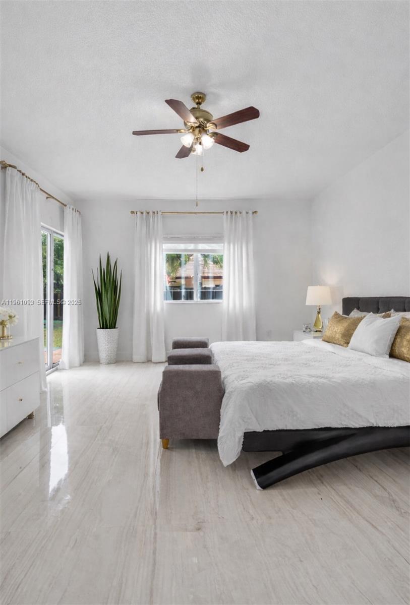 14214 Southwest 289th Terrace Homestead, FL 33033 - Photo 8 of 13 a spacious bedroom with a bed and ceiling fan