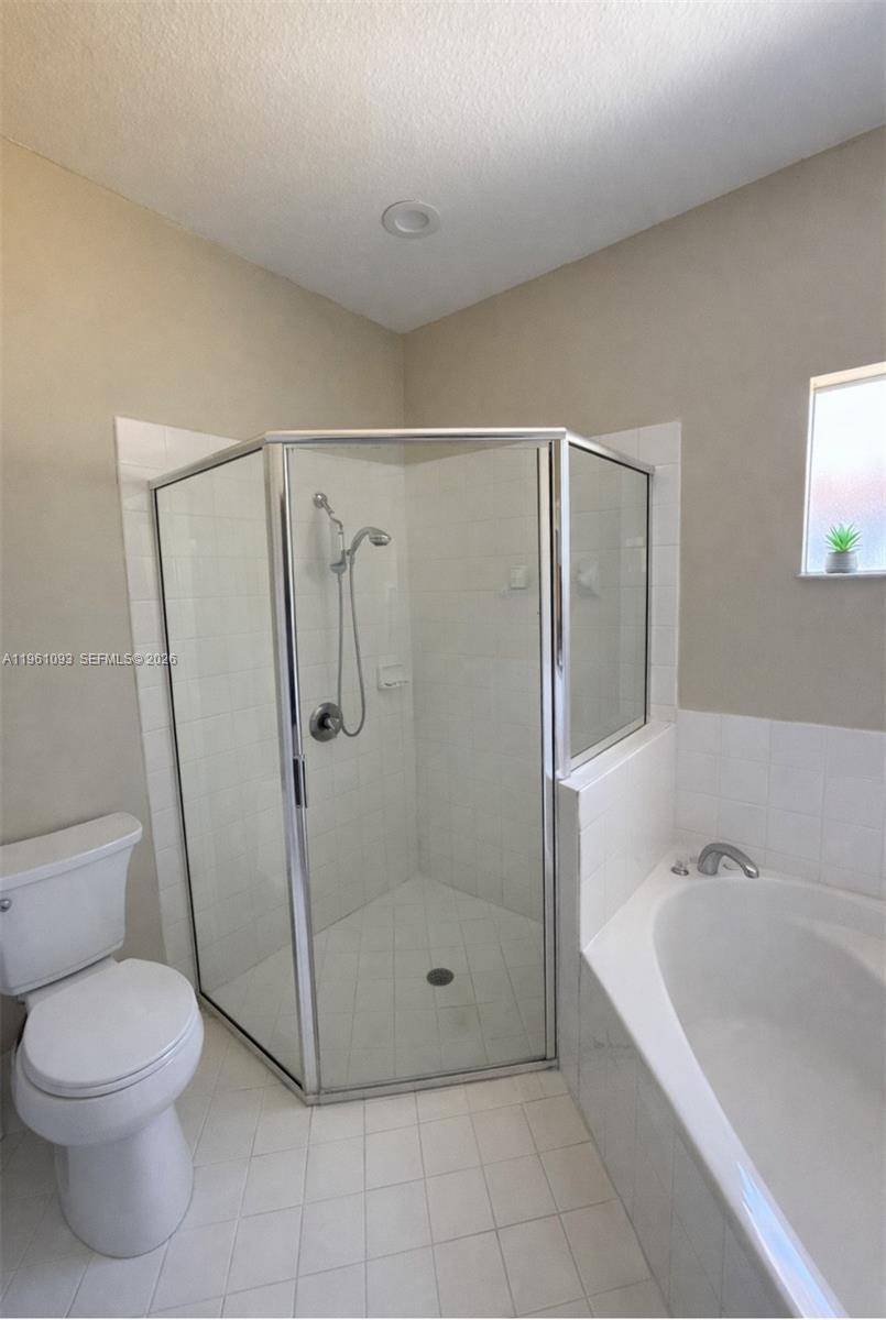 14214 Southwest 289th Terrace Homestead, FL 33033 - Photo 10 of 13 a bathroom with a granite countertop bathtub shower and toilet