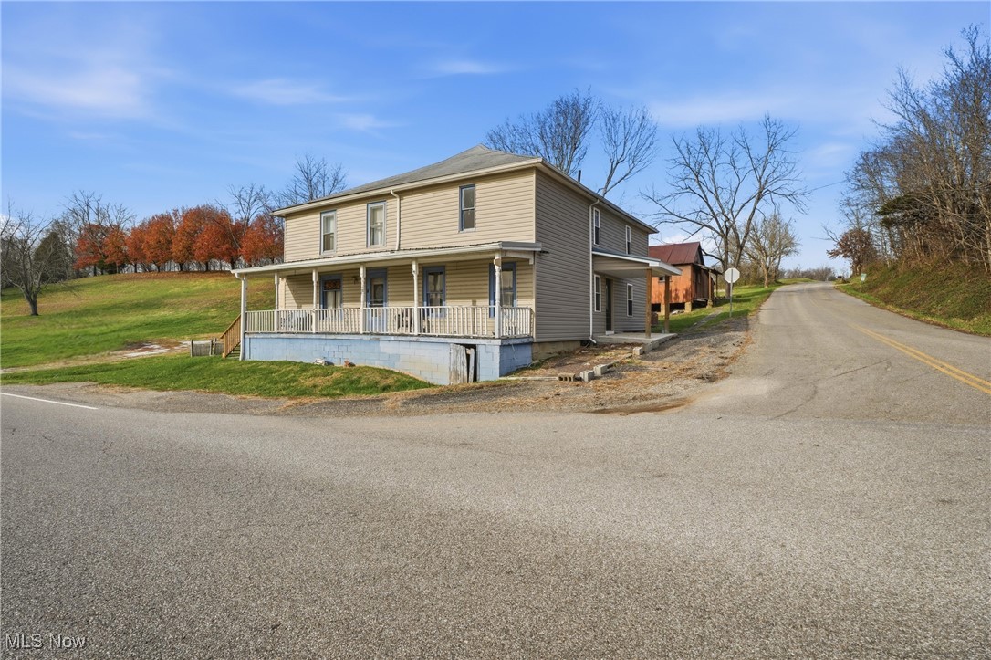 8045 Veto Road Belpre, OH 45714 - Photo 1 of 50 View of front of property featuring a porch, driveway, and a front lawn