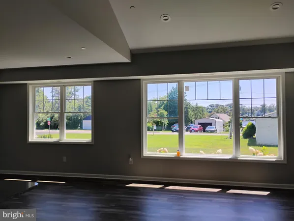a room with wooden floor and a window