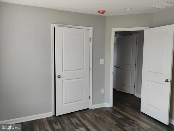 a view of hallway with wooden floor